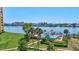 Community swimming pool surrounded by lush landscaping with nearby docks and views of the bay at 736 Island Way # 303, Clearwater Beach, FL 33767