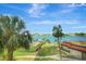 Beautiful view of the water, pool, palm trees, lush landscaping and boat docks from the property at 736 Island Way # 303, Clearwater Beach, FL 33767