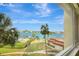 Beautiful view of the water, pool, palm trees, lush landscaping and boat docks from the property at 736 Island Way # 303, Clearwater Beach, FL 33767