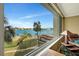 Beautiful view of the water, pool, palm trees, lush landscaping and boat docks from the property at 736 Island Way # 303, Clearwater Beach, FL 33767