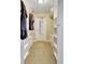 Long walk-in closet with custom shelving, providing ample storage for clothing and accessories at 736 Island Way # 303, Clearwater Beach, FL 33767
