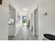 Open hallway leads to the front door, showcasing the clean lines and neutral tones of the home's interior at 7822 Radcliffe Cir, Port Richey, FL 34668