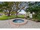 Outdoor hot tub in a community setting with landscaping, a nearby residence, and a welcoming, relaxing atmosphere at 7822 Radcliffe Cir, Port Richey, FL 34668