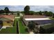 Overhead shot of a house with a fenced backyard, pool and well-kept lawn at 7944 Royal Hart Dr, New Port Richey, FL 34653