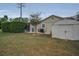 Landscaped backyard featuring a shed, screened in pool, and a tree at 7944 Royal Hart Dr, New Port Richey, FL 34653