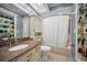 Bright bathroom with updated vanity, decorative shelves, and neutral colored walls at 7944 Royal Hart Dr, New Port Richey, FL 34653
