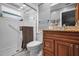 Bathroom featuring updated vanity, framed mirror, and a shower with glass doors at 7944 Royal Hart Dr, New Port Richey, FL 34653