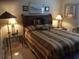 Cozy bedroom featuring a queen bed, warm lighting, and inviting ambiance at 7944 Royal Hart Dr, New Port Richey, FL 34653