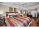 Spacious bedroom featuring a king bed, sitting area, and stylish decor at 7944 Royal Hart Dr, New Port Richey, FL 34653
