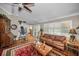 Comfortable living room with hardwood floors, ceiling fan, and bright windows at 7944 Royal Hart Dr, New Port Richey, FL 34653