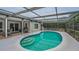 Inviting screened in pool area featuring comfortable lounge chairs for relaxation at 7944 Royal Hart Dr, New Port Richey, FL 34653