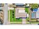 Top-down view of home with brick driveway, manicured lawn, and proximity to a screened-in pool at 8392 137Th Ln, Seminole, FL 33776