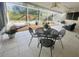 Enclosed patio offers tile floors, ceiling fans and furniture overlooking landscaped garden at 8618 Snowy Owl Way, Tampa, FL 33647