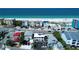 Stunning aerial view showcasing beachfront property with direct access to the white sand beach and ocean at 9921 Gulf Blvd, Treasure Island, FL 33706