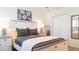 Well-lit bedroom features a decorative headboard, closet space, and an accent mirror at 9921 Gulf Blvd, Treasure Island, FL 33706