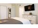 Bright bedroom featuring a large TV, a spacious dresser, and closet space at 9921 Gulf Blvd, Treasure Island, FL 33706