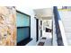 Welcoming entrance featuring a stone accent wall, modern lighting, and stair access at 9921 Gulf Blvd, Treasure Island, FL 33706