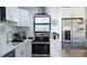 Modern kitchen featuring stainless steel appliances, ample countertop space, and stylish finishes at 9921 Gulf Blvd, Treasure Island, FL 33706
