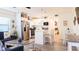 Open living and kitchen area with stainless steel appliances, island seating, and dining area at 9921 Gulf Blvd, Treasure Island, FL 33706