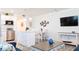 Open living and kitchen area with stainless steel appliances, island seating, and dining area at 9921 Gulf Blvd, Treasure Island, FL 33706