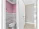 Compact bathroom featuring marbled walls and updated fixtures, conveniently located near a hall storage cabinet at 12110 75Th St, Largo, FL 33773