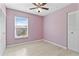 Bright bedroom features a ceiling fan, large window and spacious closet at 12110 75Th St, Largo, FL 33773