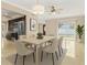Bright dining room features an elegant light fixture, and is adjacent to the modern kitchen at 12110 75Th St, Largo, FL 33773