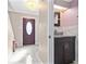 Elegant entryway featuring a decorative door, chandelier, and a modern half bath at 12110 75Th St, Largo, FL 33773