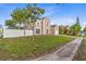 Charming two-story home featuring a well-manicured lawn and a classic architectural design, freshly painted, with lovely landscape at 12110 75Th St, Largo, FL 33773