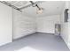 Spacious garage with epoxy flooring, ample shelving for storage, and updated water heater at 12110 75Th St, Largo, FL 33773