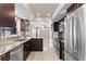Modern kitchen with stainless steel appliances, granite countertops, and elegant dark wood cabinetry at 12110 75Th St, Largo, FL 33773