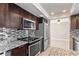Beautiful kitchen featuring dark cabinets, granite countertops, tile backsplash and stainless steel appliances at 12110 75Th St, Largo, FL 33773