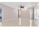 Bright and spacious room featuring modern tile flooring, ample natural light, and a ceiling fan at 12110 75Th St, Largo, FL 33773