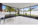 Large screened porch with tile flooring and views of the spacious backyard at 12110 75Th St, Largo, FL 33773