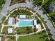 Aerial view of community pool, splashpad, playground, and meticulously landscaped grounds at 12280 Lyon Pine Ln, Odessa, FL 33556