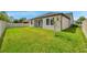 Expansive backyard with verdant lawn and a white privacy fence, perfect for outdoor activities at 12280 Lyon Pine Ln, Odessa, FL 33556