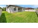 Well-maintained backyard featuring lush green grass and a charming home exterior at 12280 Lyon Pine Ln, Odessa, FL 33556