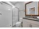 Bathroom featuring a glass-enclosed shower, granite countertops, and white cabinets at 12280 Lyon Pine Ln, Odessa, FL 33556
