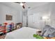 bedroom features wood-look flooring, white door, ceiling fan, and neutral wall color at 12280 Lyon Pine Ln, Odessa, FL 33556