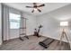Spacious bedroom is being used as a workout room and features plank flooring and ample light at 12280 Lyon Pine Ln, Odessa, FL 33556