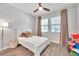 room has wood-look flooring, two windows, a ceiling fan and toys at 12280 Lyon Pine Ln, Odessa, FL 33556
