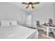 This bedroom has wood flooring, ceiling fan, and a desk at 12280 Lyon Pine Ln, Odessa, FL 33556