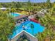 Fun splashpad and luxurious community pool area, surrounded by lush landscaping and comfortable seating at 12280 Lyon Pine Ln, Odessa, FL 33556