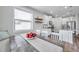 Bright dining area with a rustic wood table, white chairs, and a view to the kitchen at 12280 Lyon Pine Ln, Odessa, FL 33556