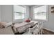 Bright dining area with wood table, white chairs, and bench seating at 12280 Lyon Pine Ln, Odessa, FL 33556