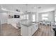 Open concept kitchen featuring a large island and seamlessly connected to the living area at 12280 Lyon Pine Ln, Odessa, FL 33556
