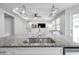 Modern kitchen with sleek granite countertops and an open view into the living room at 12280 Lyon Pine Ln, Odessa, FL 33556