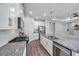 Open kitchen with white cabinets, subway tile backsplash, and a granite island with sink at 12280 Lyon Pine Ln, Odessa, FL 33556
