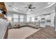 Bright living room next to an open kitchen with neutral decor and hardwood floors at 12280 Lyon Pine Ln, Odessa, FL 33556