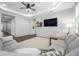 Bright living room features modern ceiling fan, recessed lighting, and neutral color palette with large tv at 12280 Lyon Pine Ln, Odessa, FL 33556